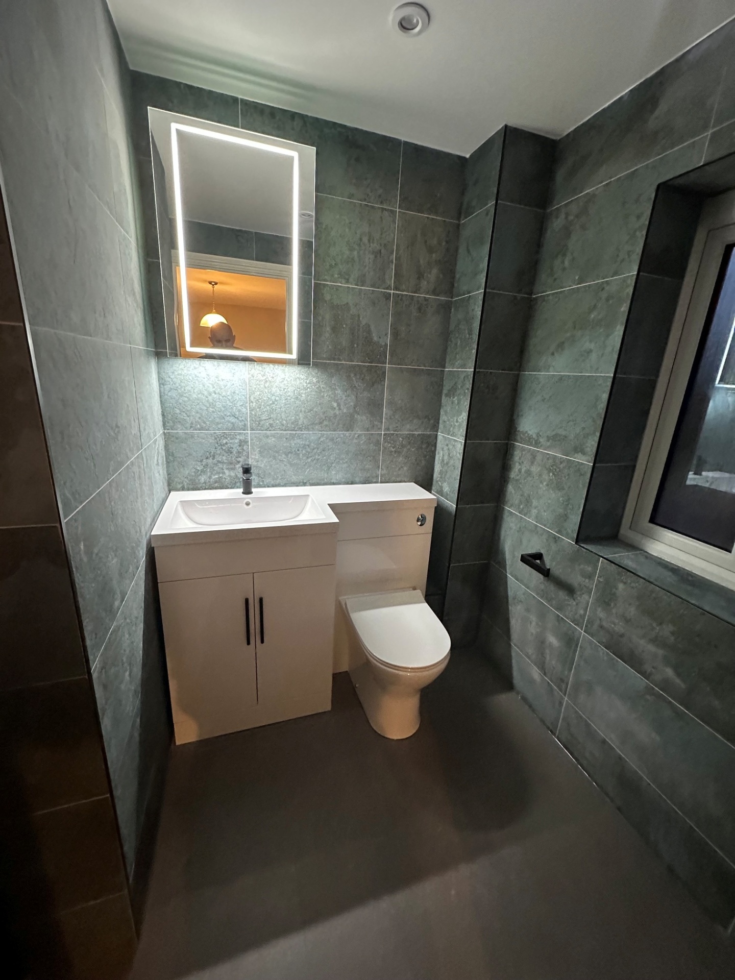 Modern grey-tiled WC & basin installation