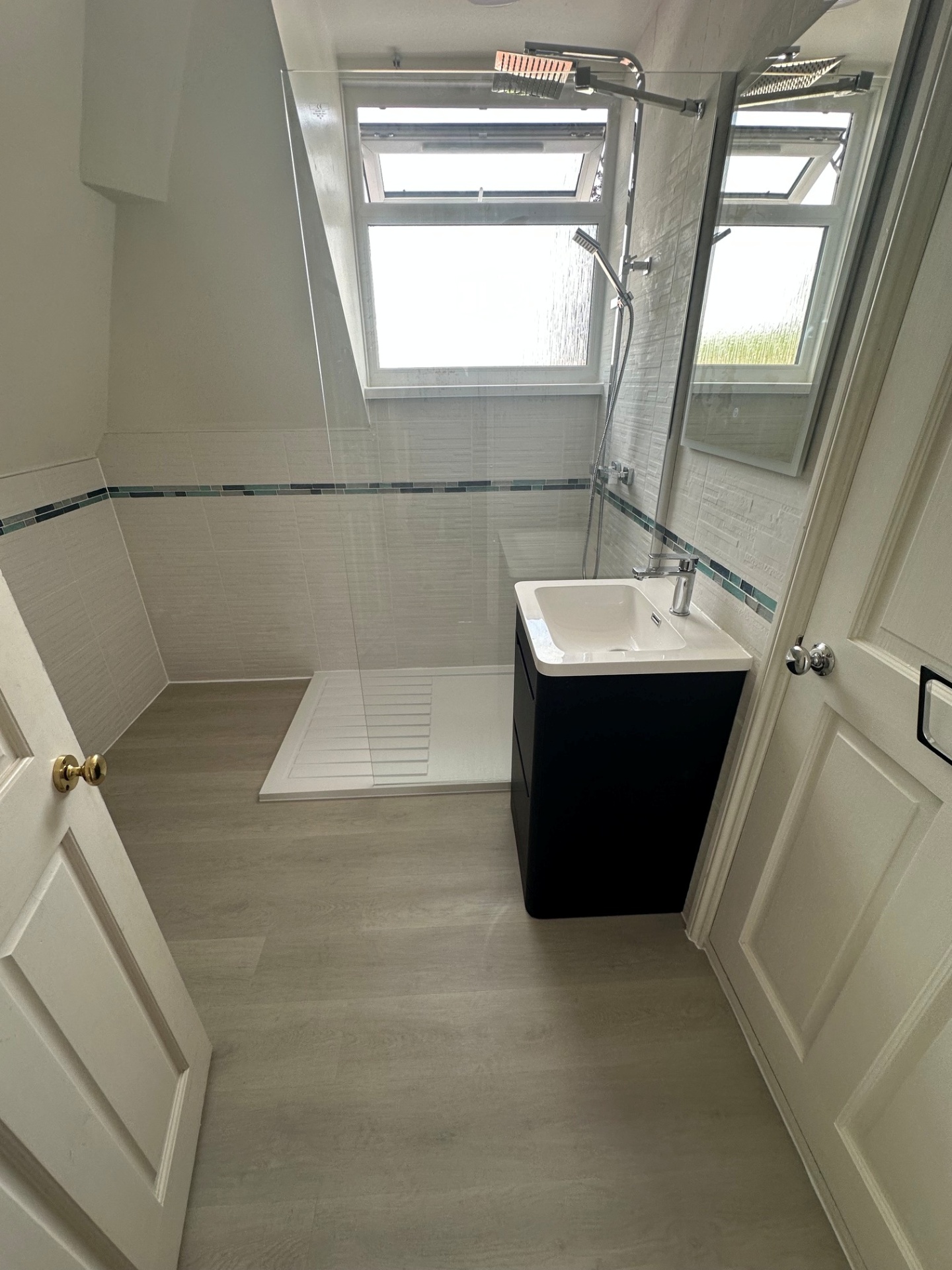 Loft shower room with walk-in tray, black vanity & Velux window
