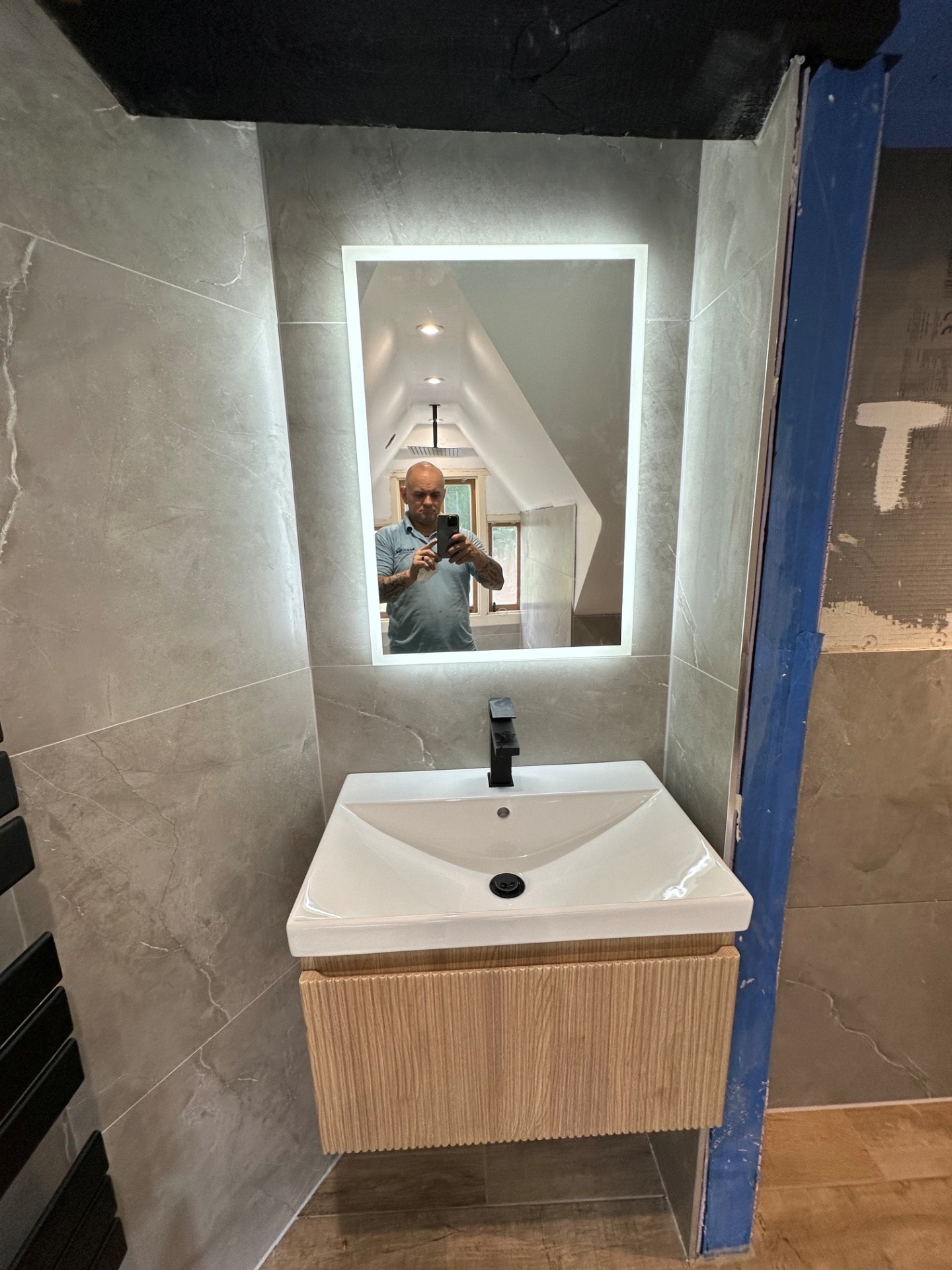 Grey marble ensuite with fluted oak vanity & LED backlit mirror
