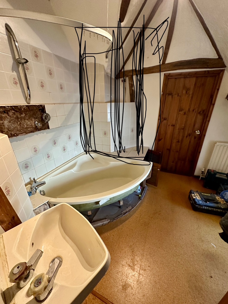 Dated cottage bathroom → beamed stone wet-room with brass shower — before