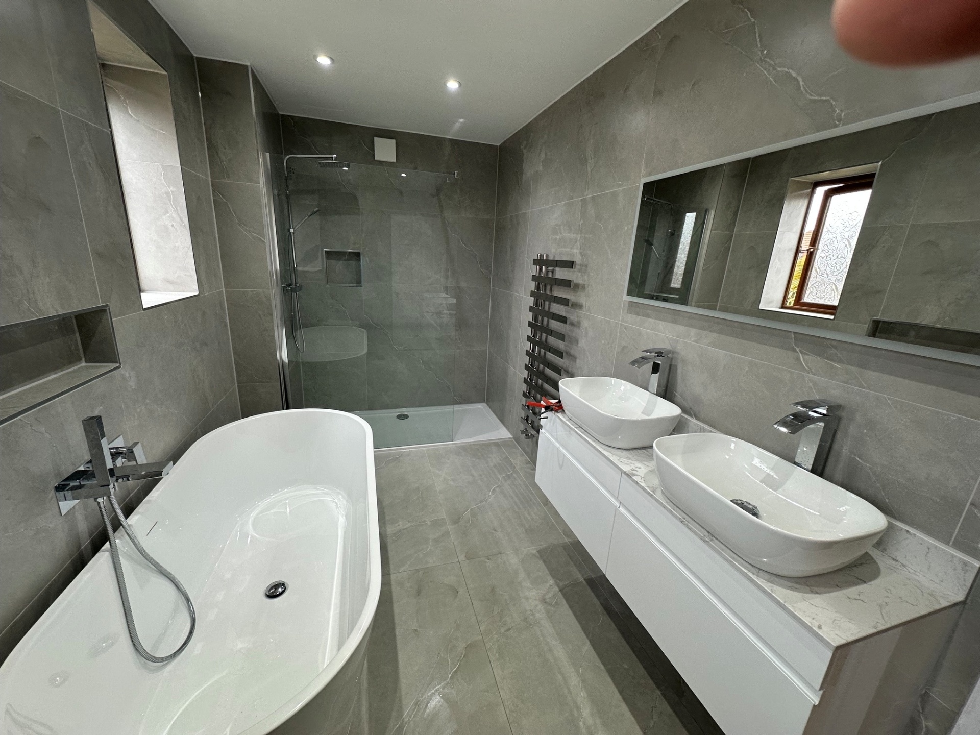 Luxury grey marble ensuite with freestanding tub, walk-in shower & double vanity